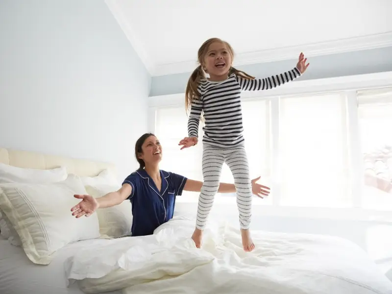 Mother and daughter enjoy fresh indoor air after professional air duct cleaning, ensuring a healthier home environment.